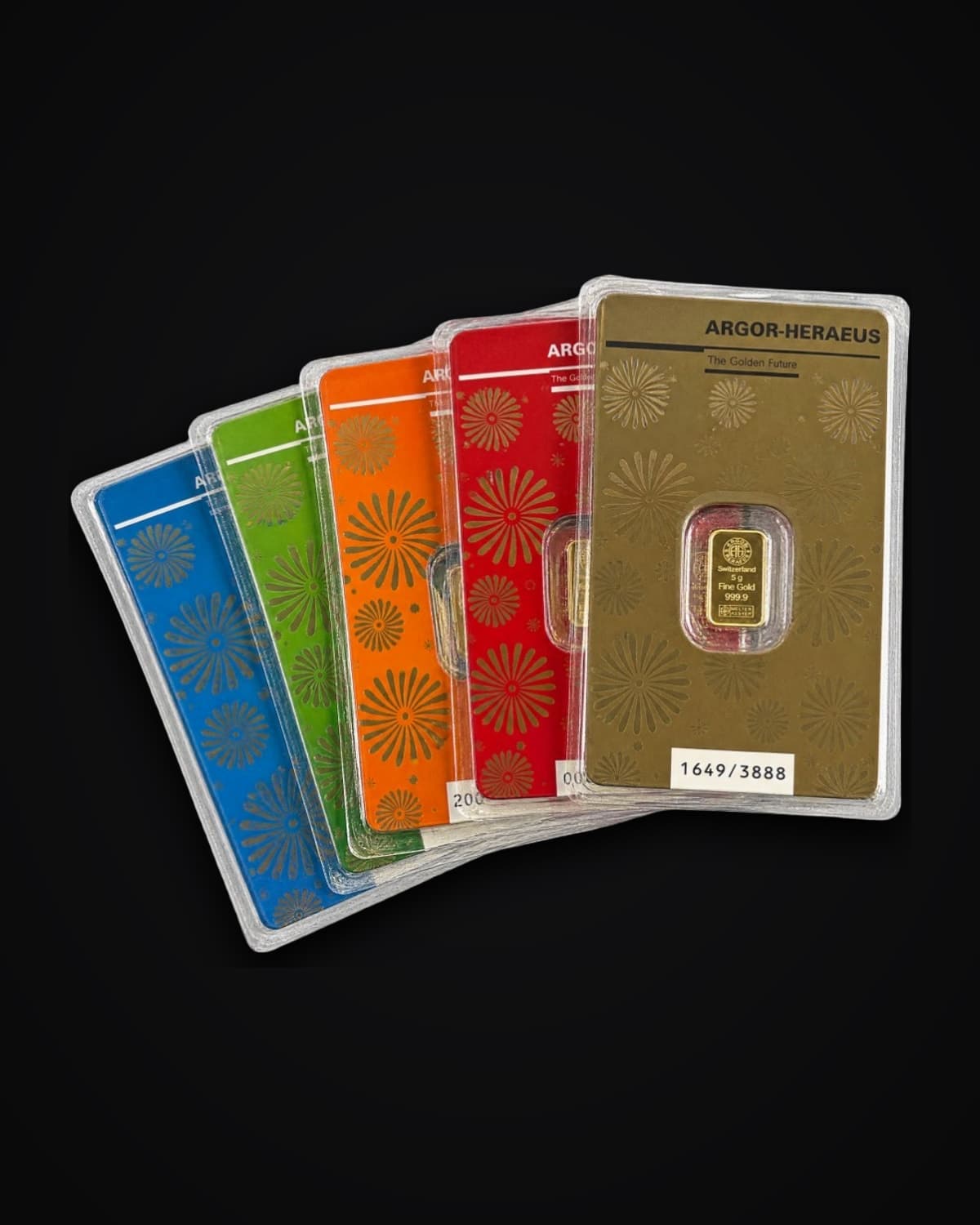 Fan of six coloured collector cards, each with a sealed gold bar