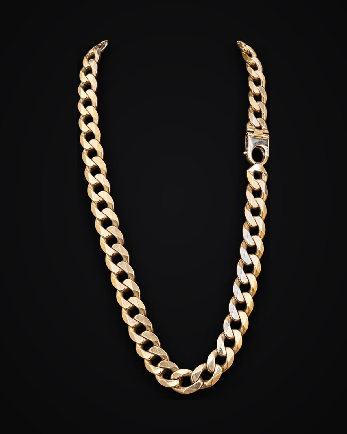 Gold curb chain, shown on a black background
