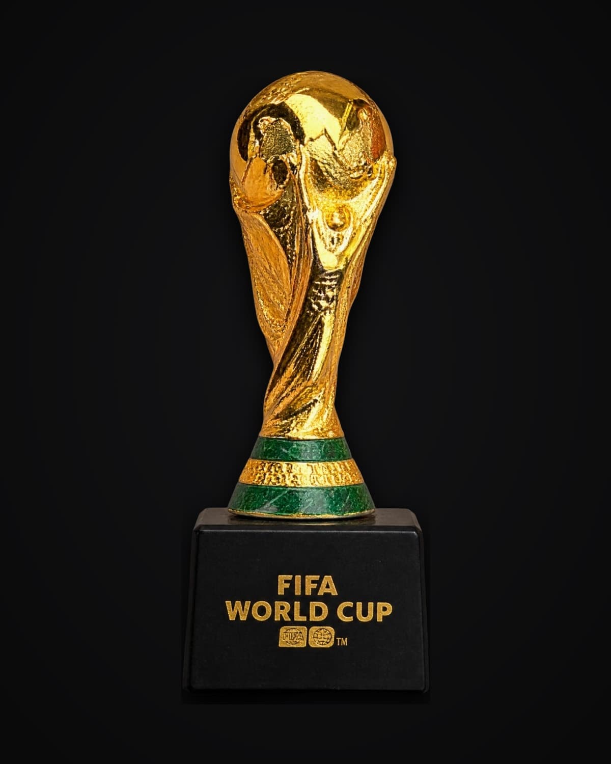 Gold-coloured FIFA World Cup trophy replica on a black base