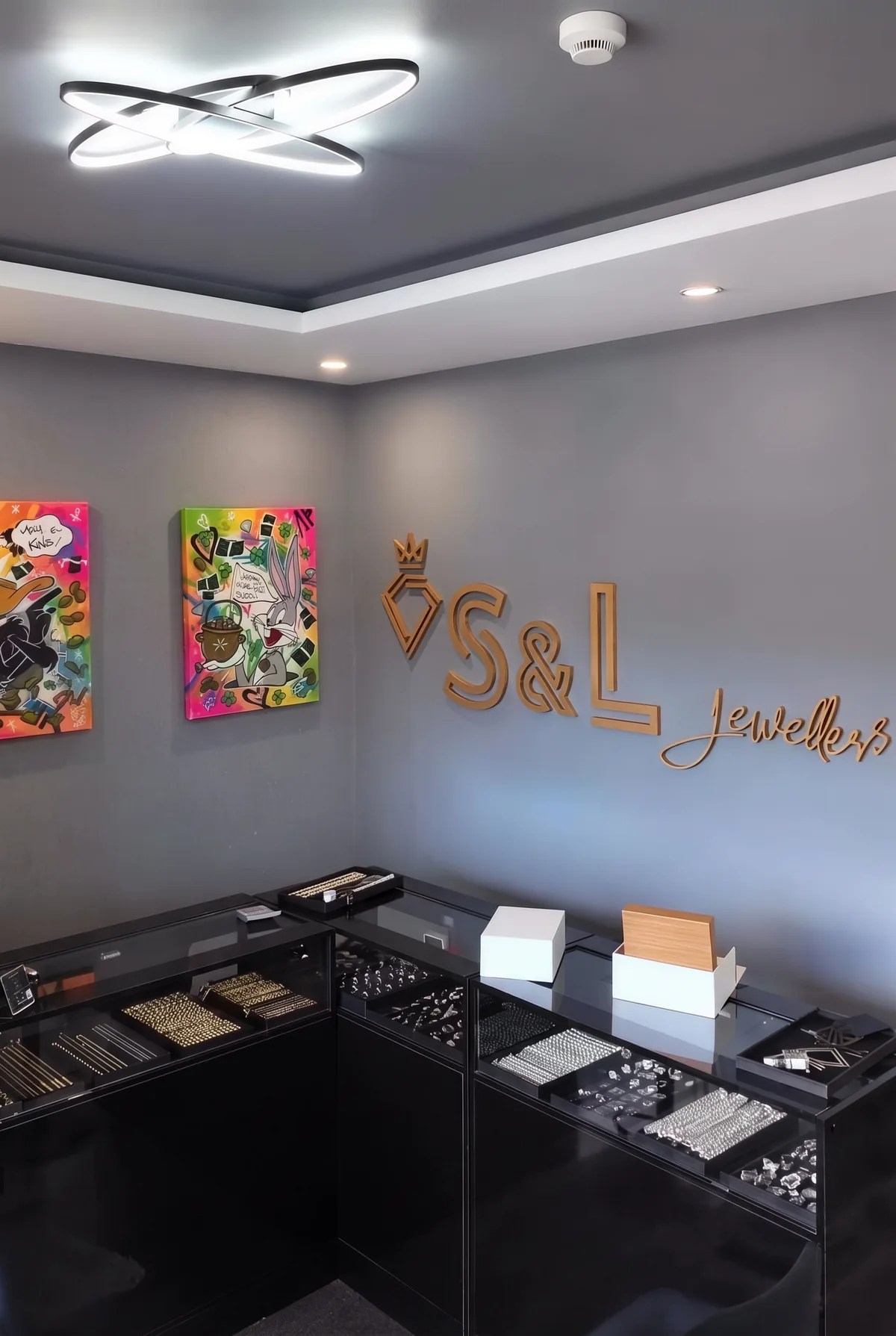 Inside S&L Jewellers: the black glass counters, the display cases and the gold S&L sign on the wall