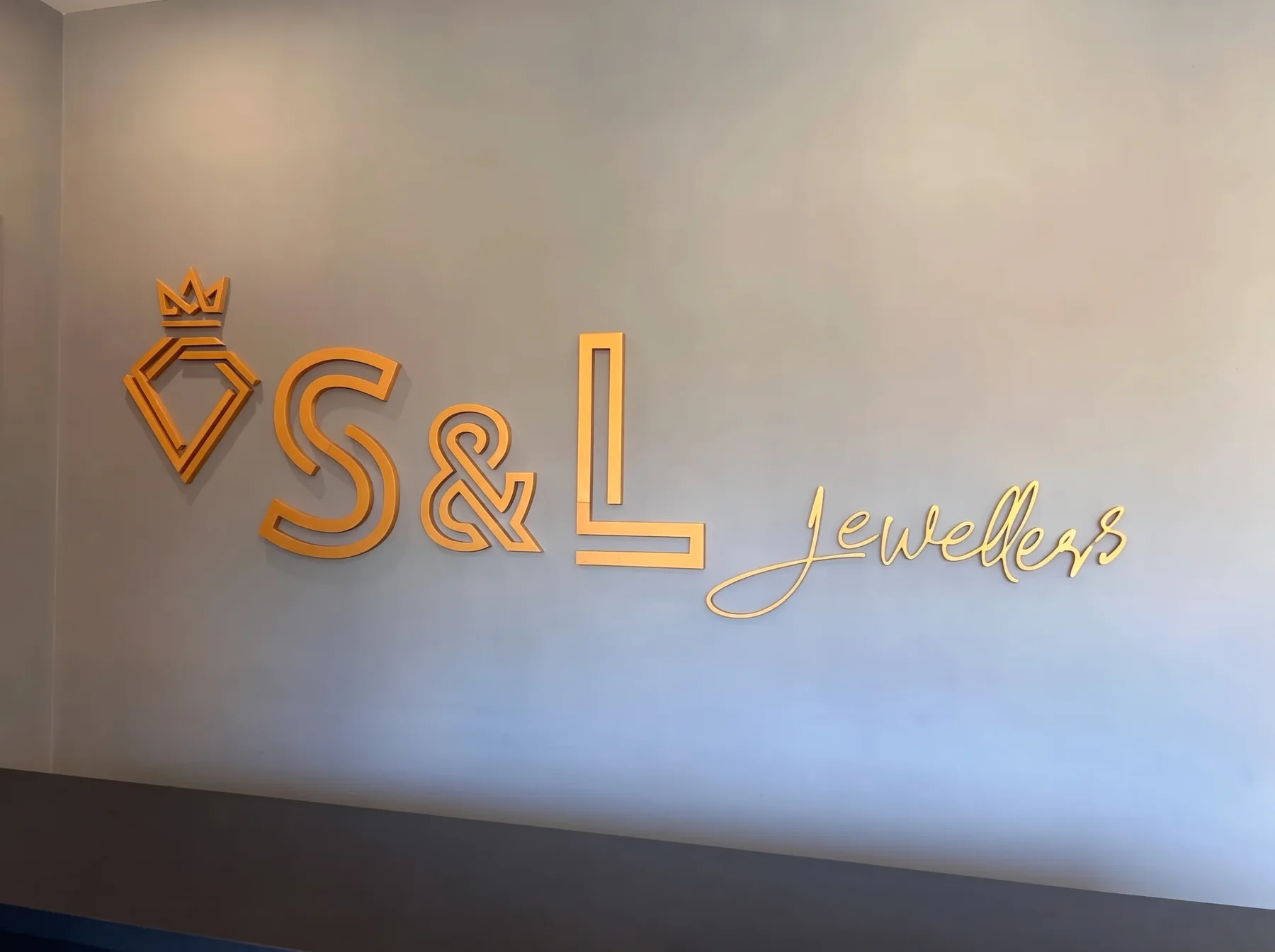 The gold S&L Jewellers sign on the wall behind the counter at 49 Cambridge Street, Cleethorpes