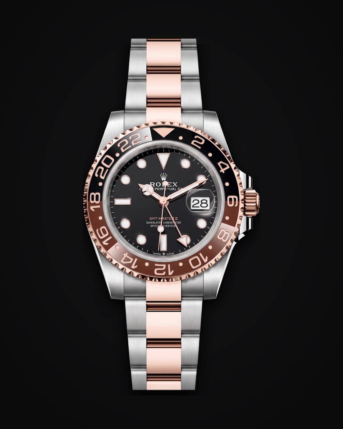 Steel and rose gold watch with a black dial and a brown and black bezel on a two-tone bracelet