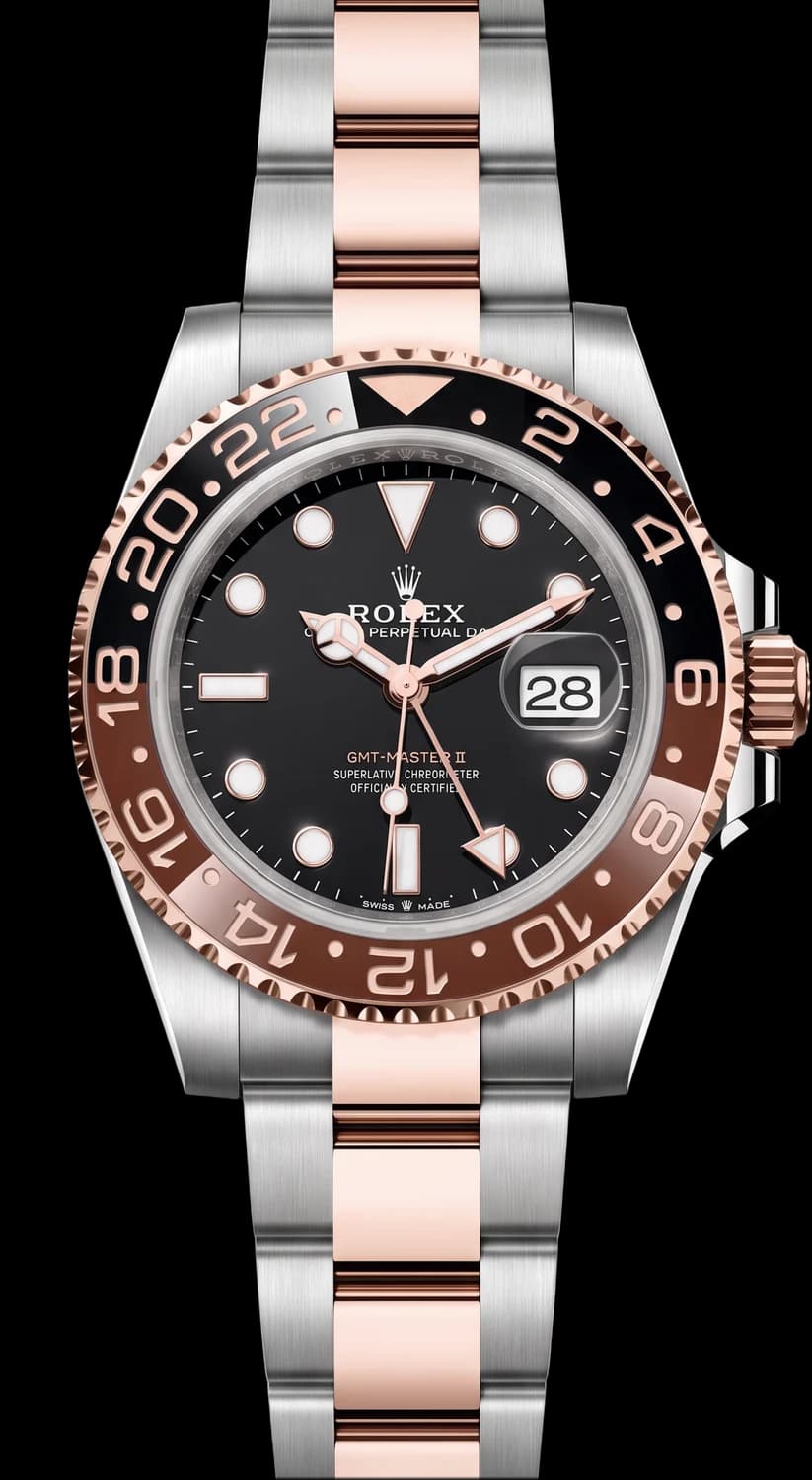 Steel and rose gold watch with a black dial and a brown and black bezel on a two-tone bracelet